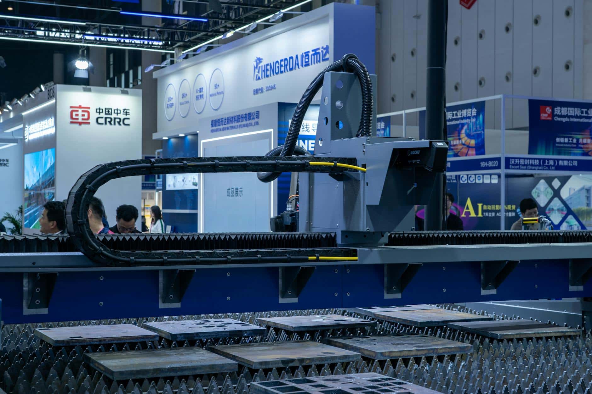 Estande chinês em feira B2B com maquinário industrial CRRC e visitantes negociando ao fundo